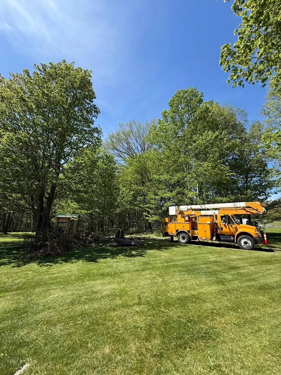 Beaver Tree Experts lift truck in field on a job site
