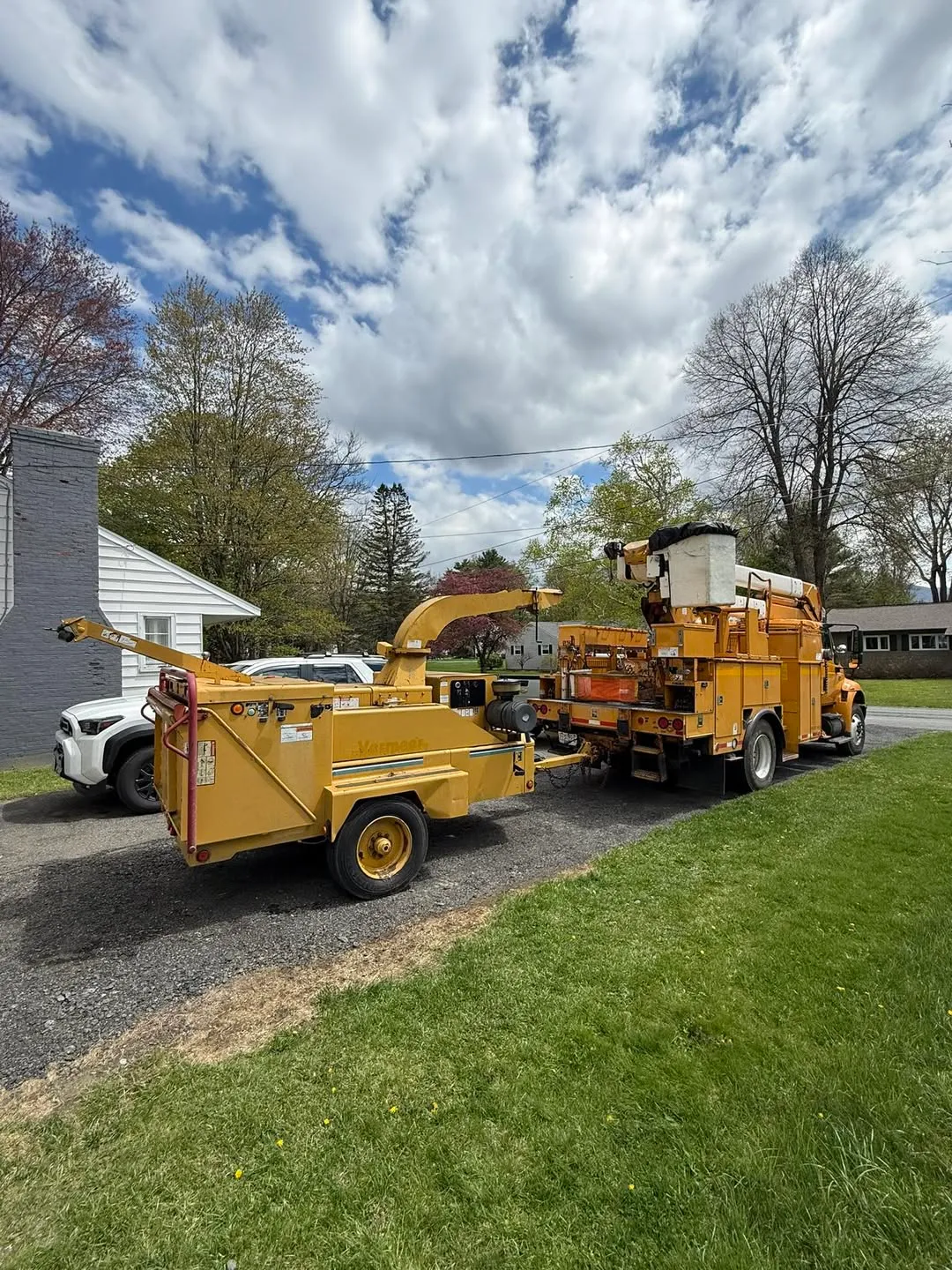 Lift equipment and wood chipper at a tree removal job